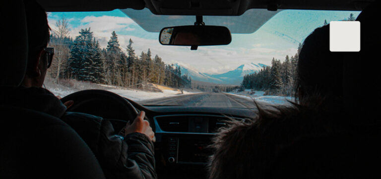 Thumbnail of dashboard inside a car with a winter scene outside.