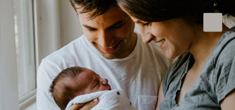 Thumbnail of couple holding their newborn.