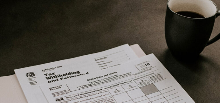 Thumbnail of tax documents beside a coffee cup.