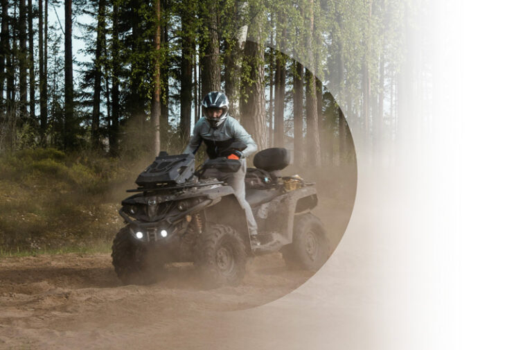 Vehicle Insurance example. Img: Person riding an atv through the woods.