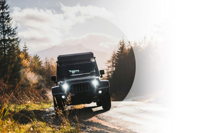 Vehicle Insurance example. Img: A jeep on the side of a road. Fall tones.