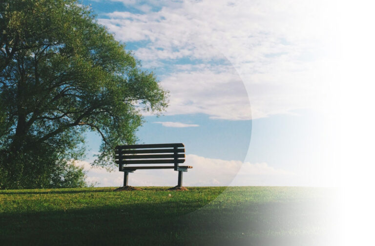 Funeral Insurance example. Img: An empty bench on a blue sky day.