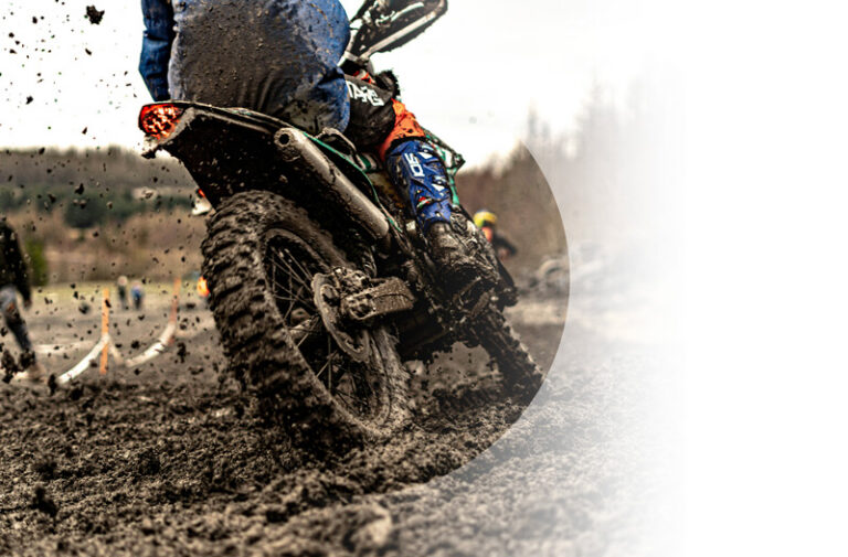 Vehicle Insurance example. Img: A muddy off-roading motorcycle.