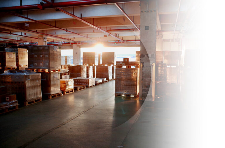 Commercial Insurance example. Img: Golden hour lighting across a warehouse filled with boxes.