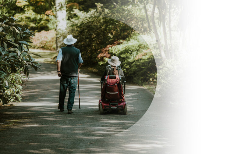 Supplemental Insurance example. Img: Two people going off into the distance, one with a cane and one on an electric wheelchair.